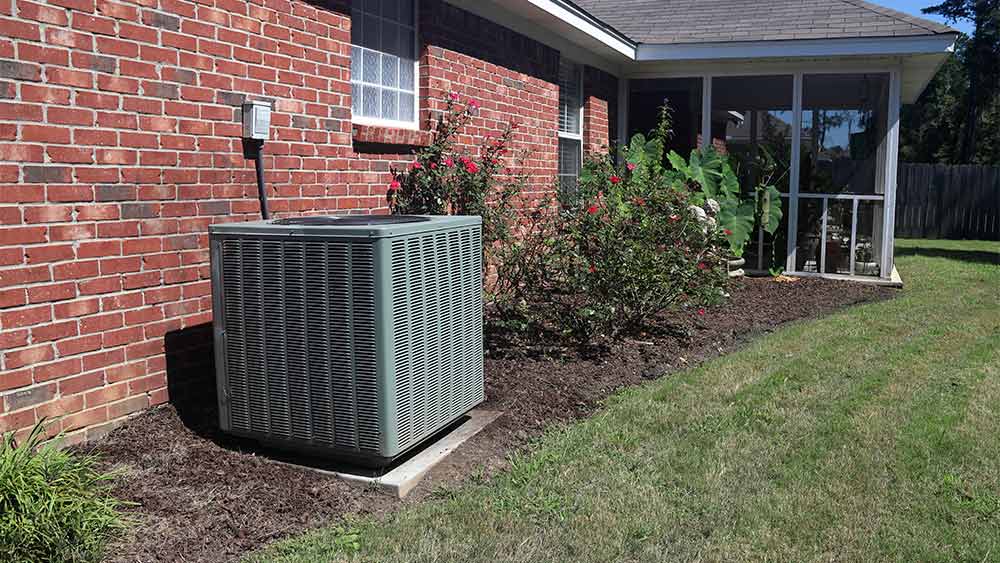Outdoor AC unit in the lawn.