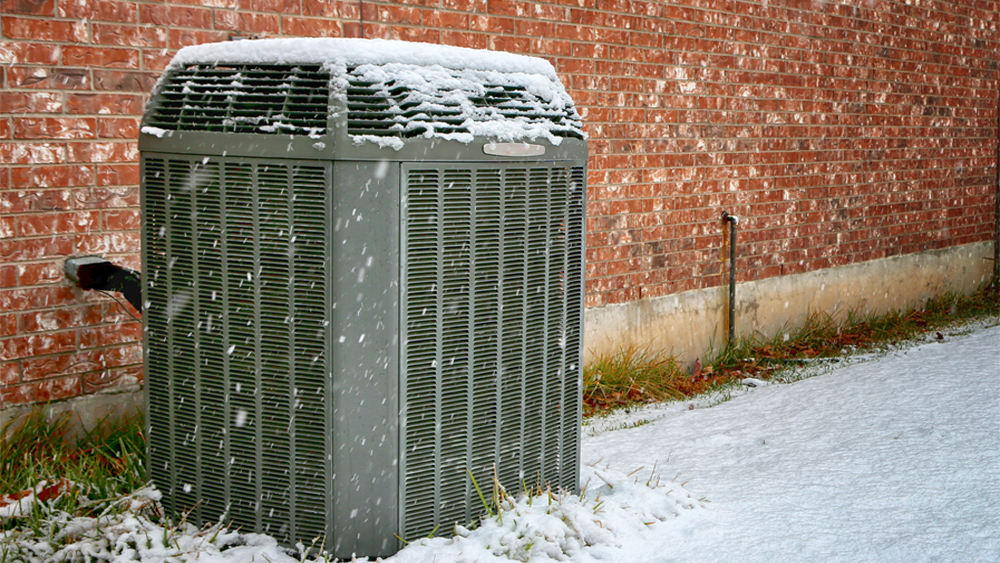 heat pump covered in snow 