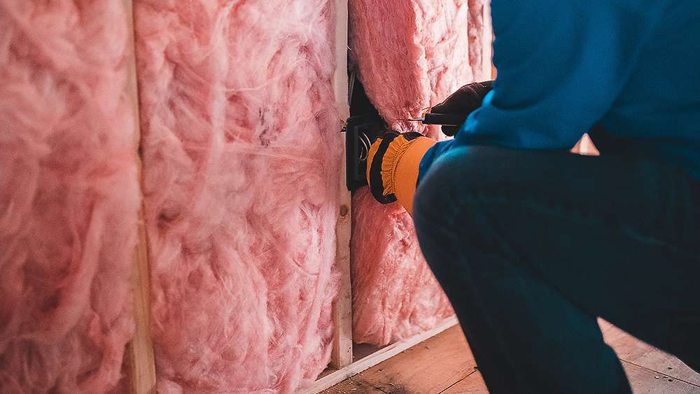 A man adding home insulation