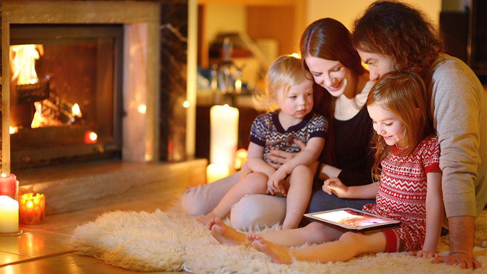 Family enjoying a show on tablet in a cozy room 