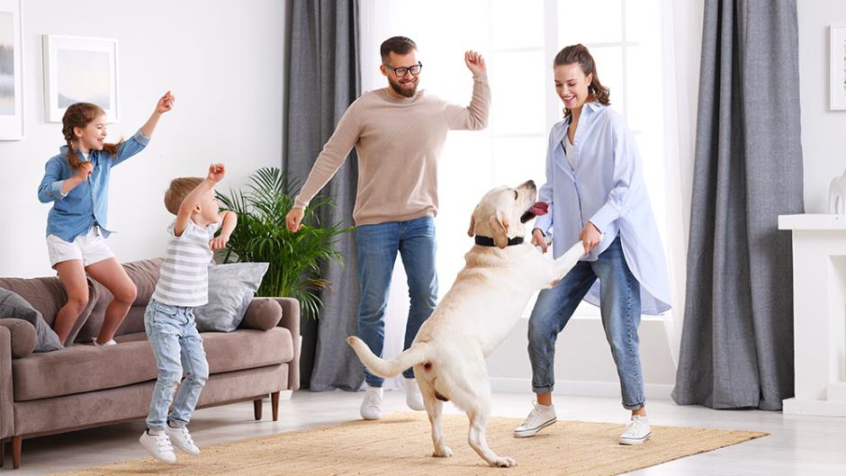 parents and kids having fun with their dog
